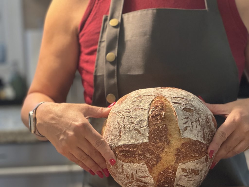 Hands kneading a fresh loaf of homemade bread